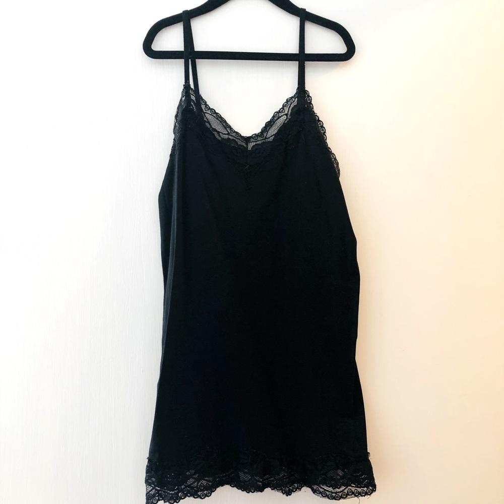 Perfect black layering tank with lace detail. Tight fit but long. Fits like a M